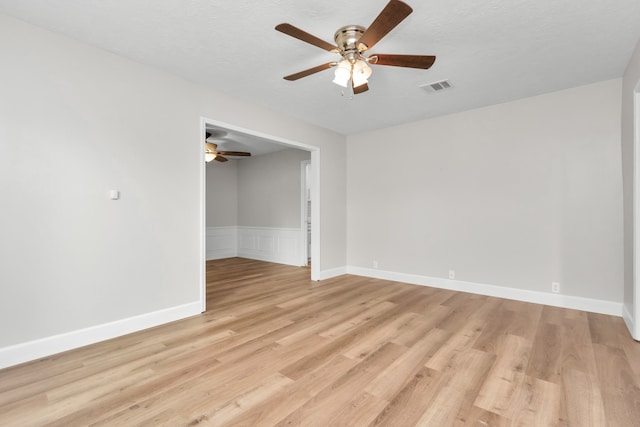 spare room featuring light hardwood / wood-style floors and ceiling fan