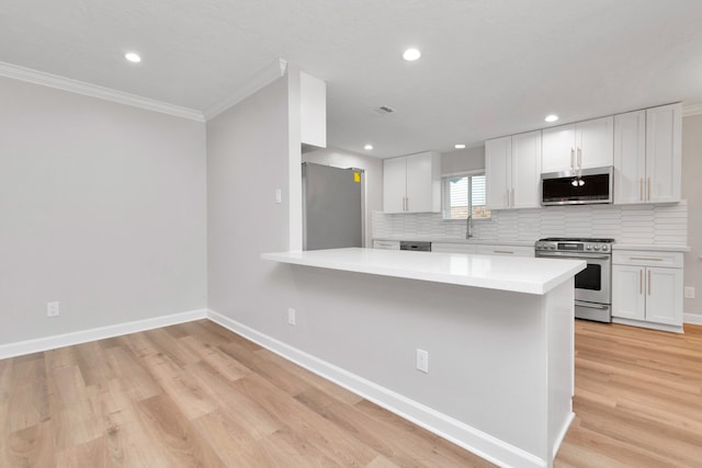 kitchen featuring light hardwood / wood-style floors, white cabinetry, and stainless steel appliances