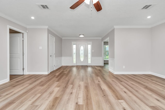 unfurnished living room with light hardwood / wood-style flooring, ornamental molding, and ceiling fan