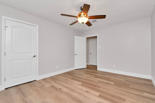 unfurnished room with ceiling fan and light wood-type flooring