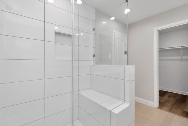 bathroom with a shower and hardwood / wood-style flooring