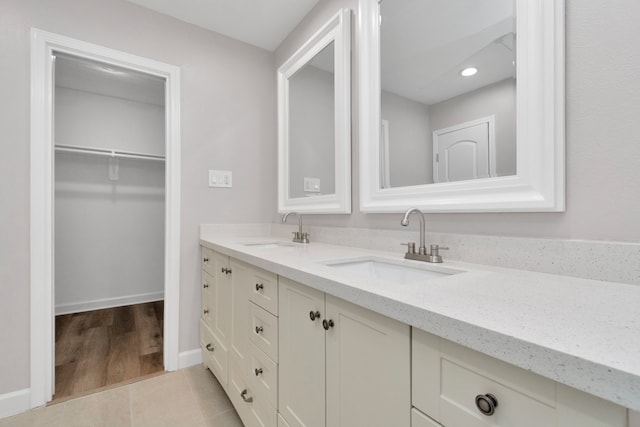 bathroom with dual vanity and hardwood / wood-style floors