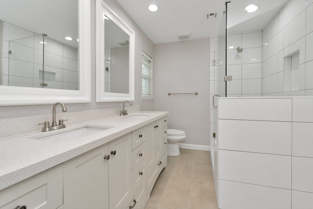 bathroom featuring double vanity, tile patterned flooring, and toilet