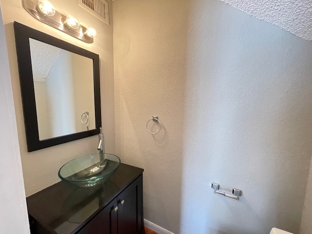 bathroom with vanity and a textured ceiling