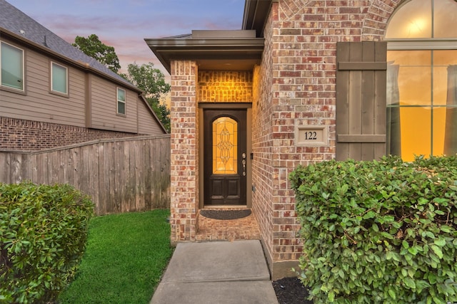 exterior entry at dusk with a yard