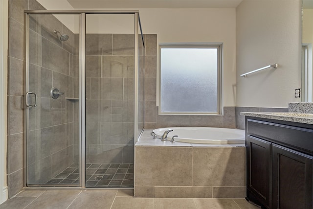 bathroom featuring vanity, tile patterned floors, and separate shower and tub