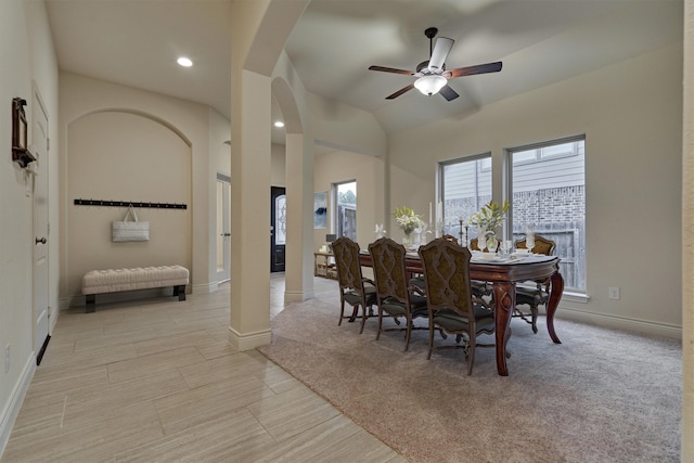 carpeted dining space with ceiling fan