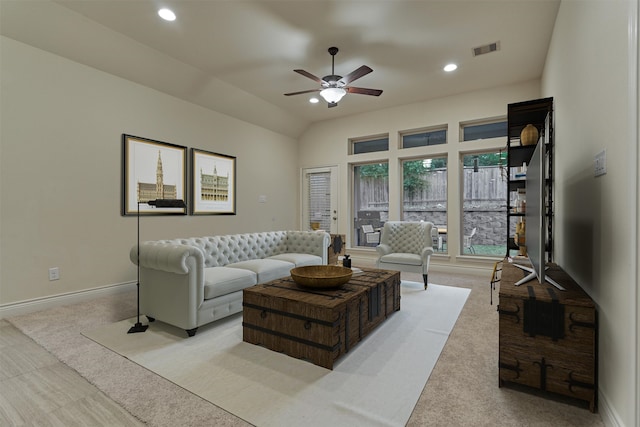 living room featuring light carpet, ceiling fan, and vaulted ceiling