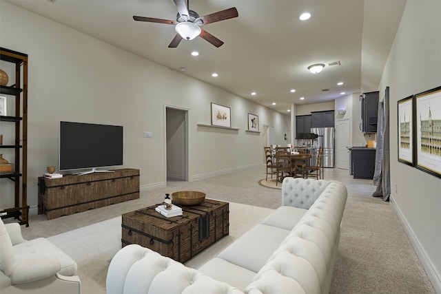 living room featuring light carpet and ceiling fan