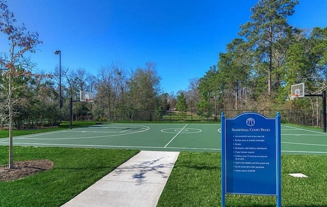 view of basketball court with a yard