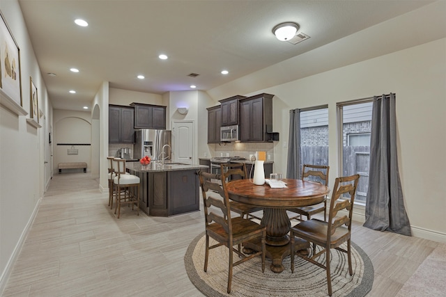 dining space with sink and light tile patterned flooring