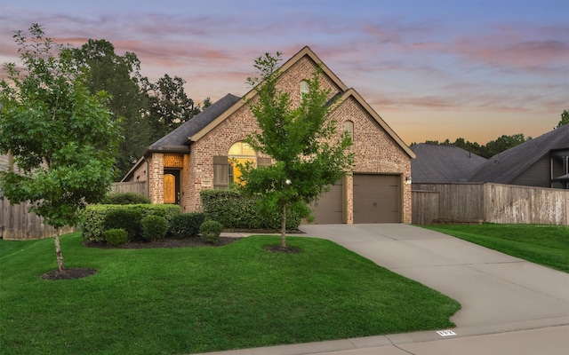 view of front of property featuring a garage and a yard