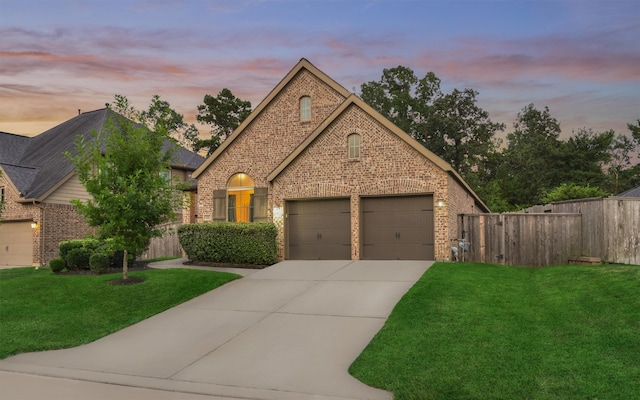 view of front of home featuring a garage and a lawn