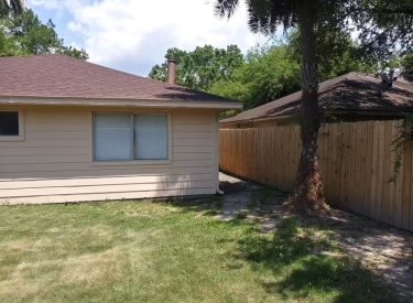 view of side of home with a lawn