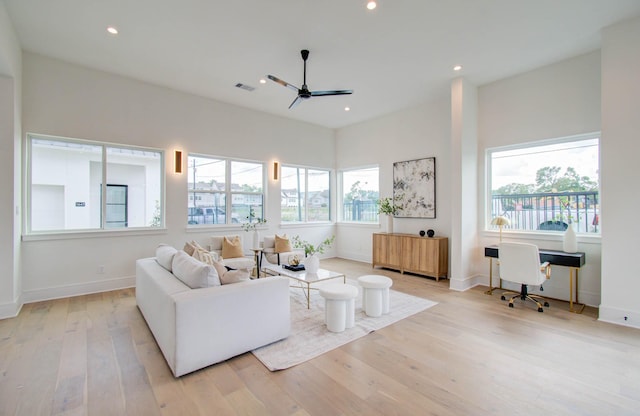 living room with light hardwood / wood-style flooring and ceiling fan