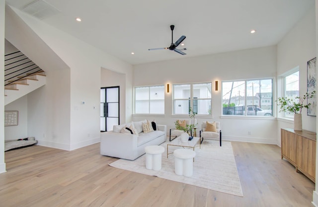 living room featuring ceiling fan and light wood-type flooring