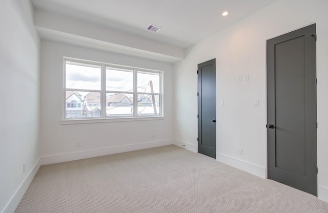 spare room with light colored carpet