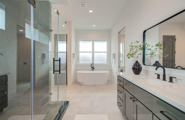 bathroom with tile patterned floors, vanity, and independent shower and bath