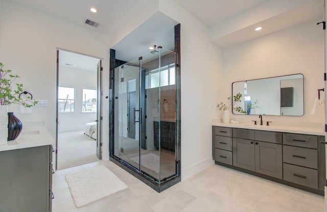 bathroom featuring plenty of natural light, a shower with door, and vanity