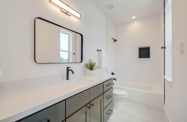 full bathroom with bathing tub / shower combination, vanity, and toilet