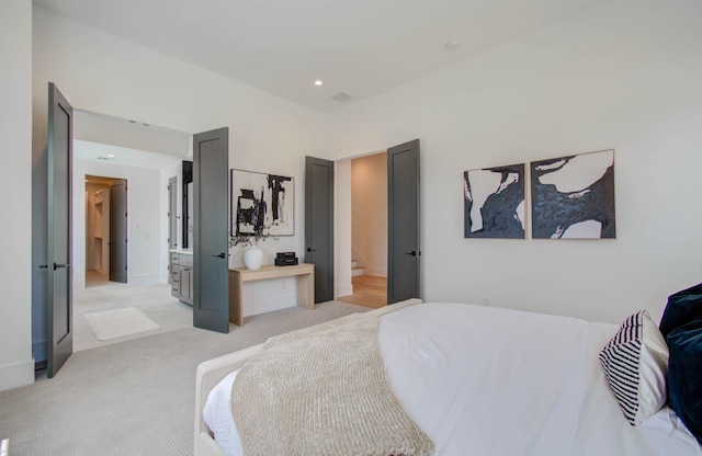 carpeted bedroom featuring ensuite bath