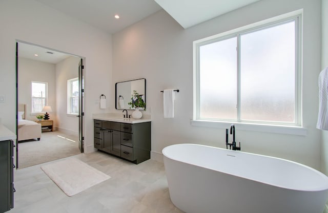 bathroom with vanity and a tub