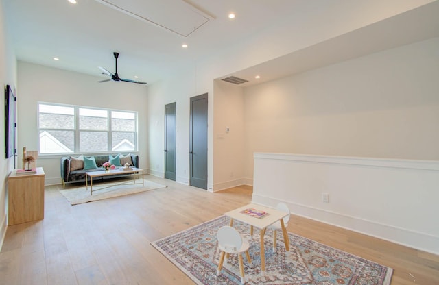 living room featuring ceiling fan and light wood-type flooring