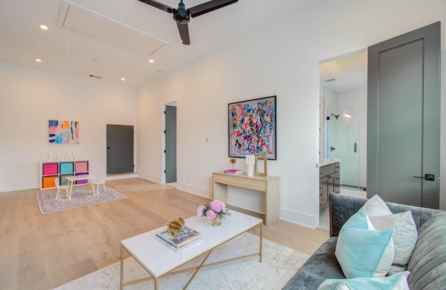 living room featuring ceiling fan and light hardwood / wood-style floors