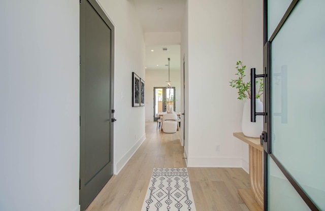 corridor with light hardwood / wood-style flooring