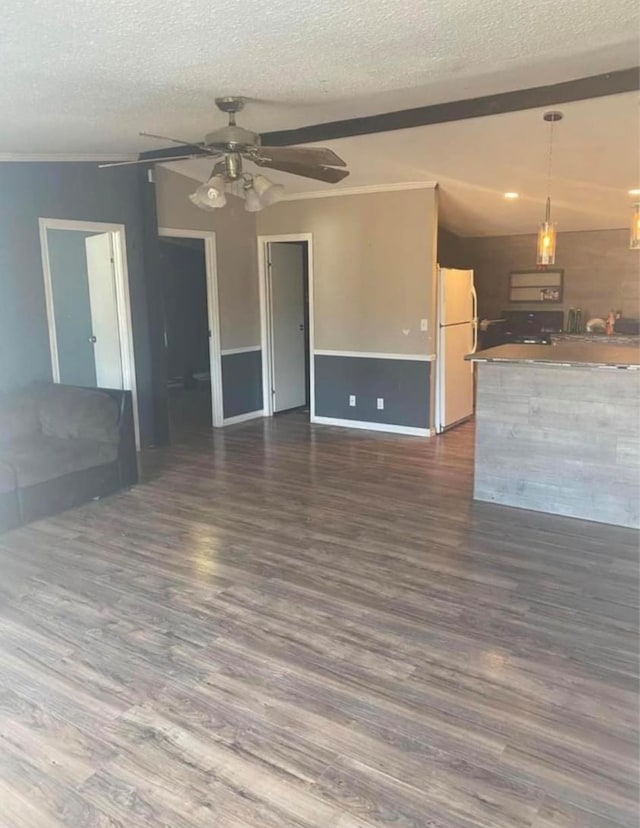 unfurnished living room with dark hardwood / wood-style floors, ceiling fan, and a textured ceiling