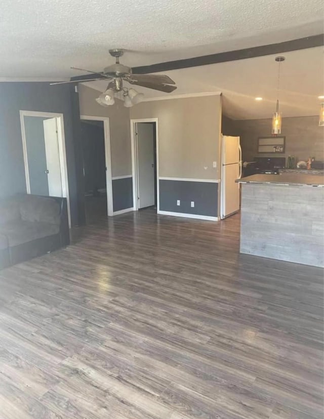 10 A Park Ln, Huntsville, TX 77320 - unfurnished living room featuring a textured ceiling, a ceiling fan, dark wood-type flooring, and baseboards