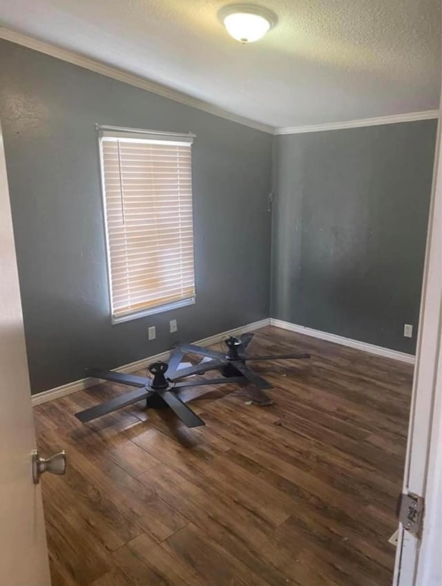 unfurnished room with crown molding, dark hardwood / wood-style floors, ceiling fan, and a textured ceiling