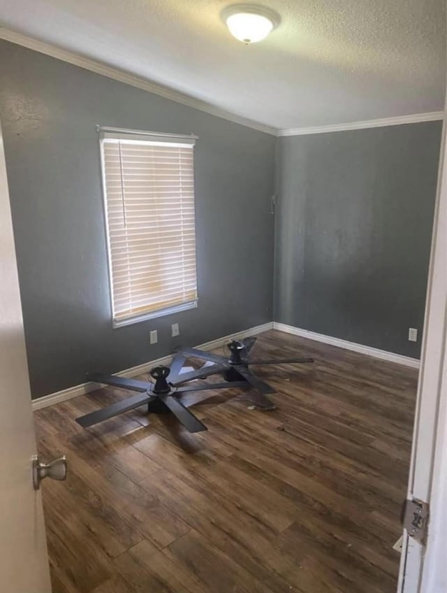 10 A Park Ln, Huntsville, TX 77320 - empty room featuring a textured ceiling, wood finished floors, ornamental molding, and baseboards