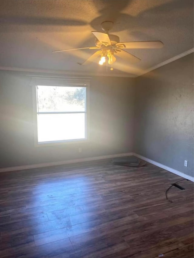 unfurnished room featuring ceiling fan, crown molding, and dark wood-type flooring