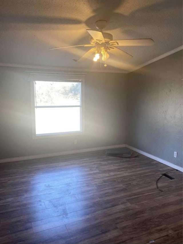 10 A Park Ln, Huntsville, TX 77320 - empty room featuring a ceiling fan, crown molding, dark wood finished floors, and baseboards