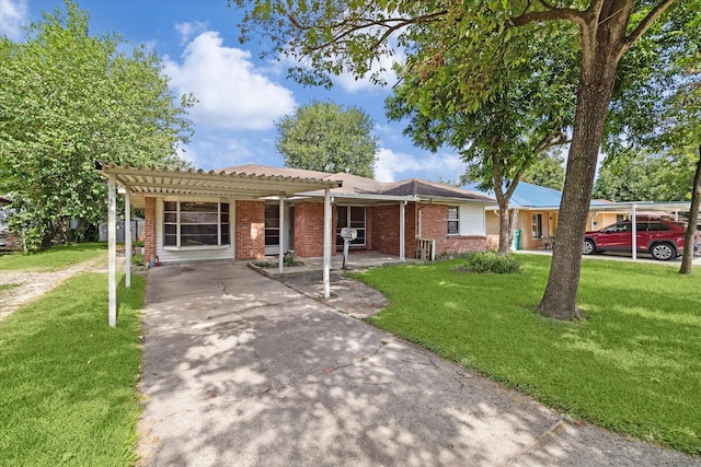 ranch-style house featuring a front yard and a carport