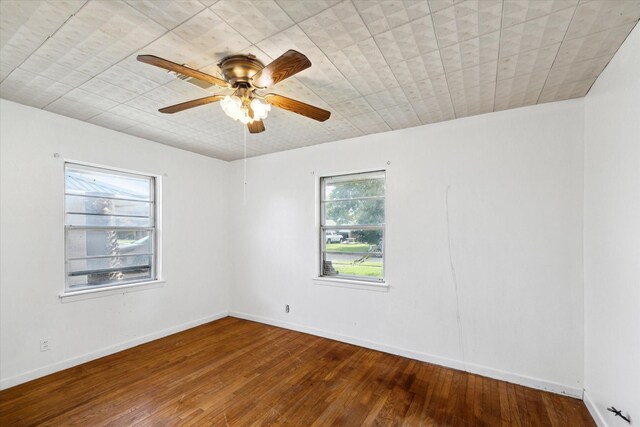 unfurnished room with hardwood / wood-style flooring and ceiling fan