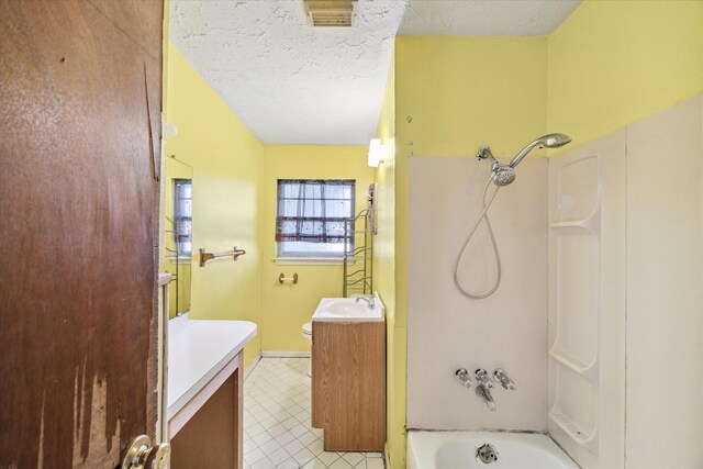 full bathroom featuring bathtub / shower combination, toilet, vanity, and a textured ceiling