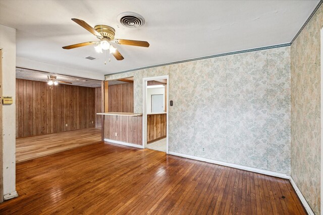 unfurnished room with ceiling fan and hardwood / wood-style floors