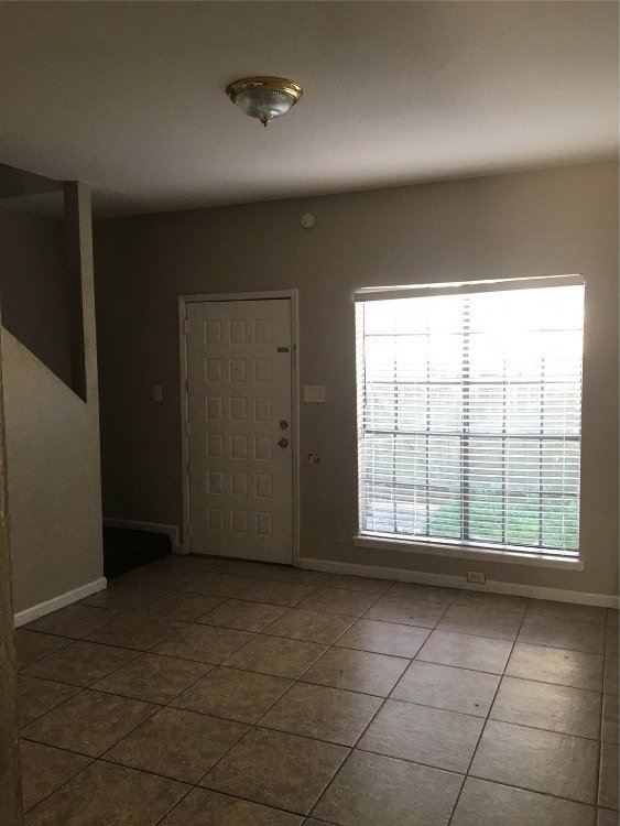 foyer entrance with dark tile patterned flooring