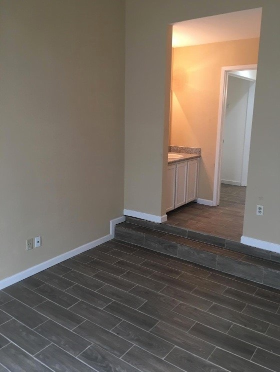 empty room with dark hardwood / wood-style floors