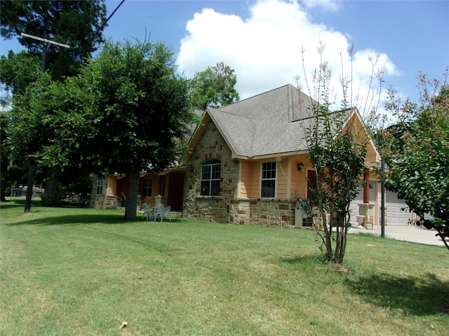 view of front of home featuring a garage and a front lawn