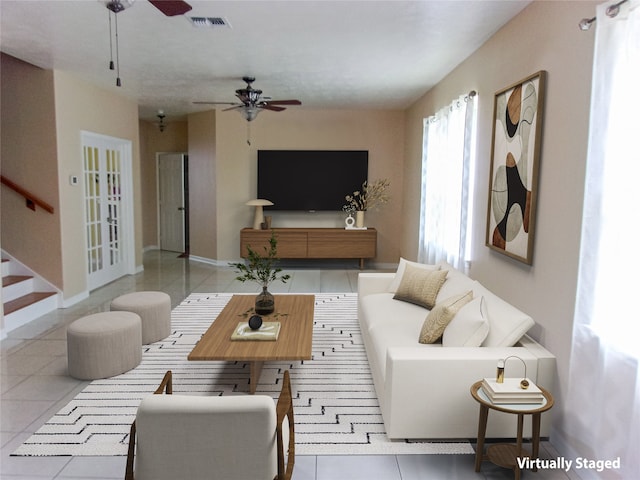 tiled living room with ceiling fan