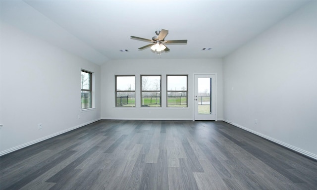 spare room featuring dark wood-type flooring, ceiling fan, and vaulted ceiling