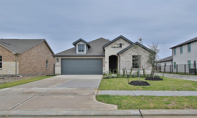 view of front of property with a garage and a front yard