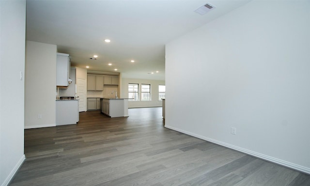 unfurnished living room with hardwood / wood-style floors and sink