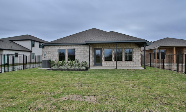 rear view of property with central AC and a lawn