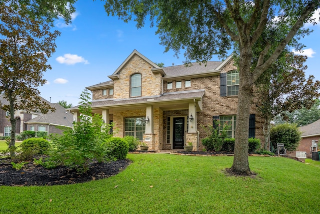 view of front of house featuring covered porch and a front yard