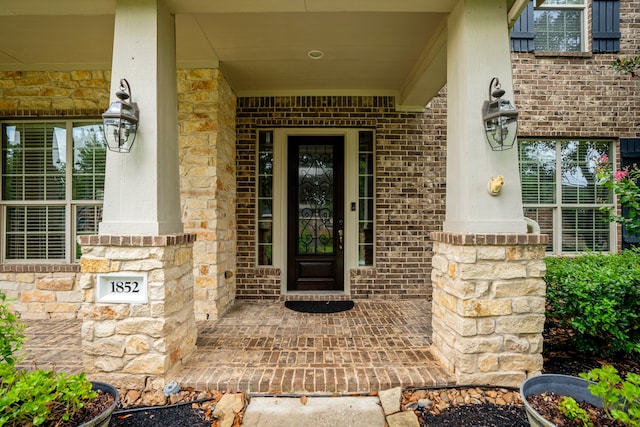 view of exterior entry with covered porch