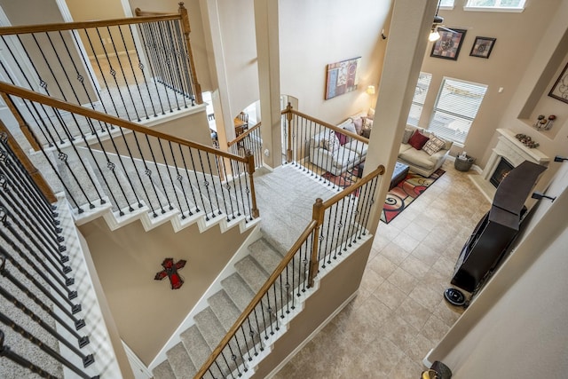 stairs featuring a high ceiling and a healthy amount of sunlight